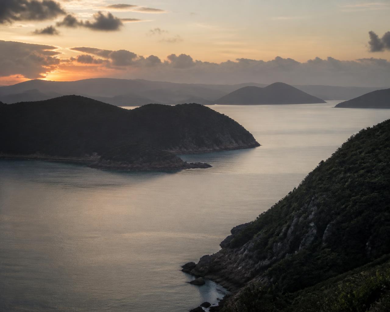 The headland enclosing the cove at dusk