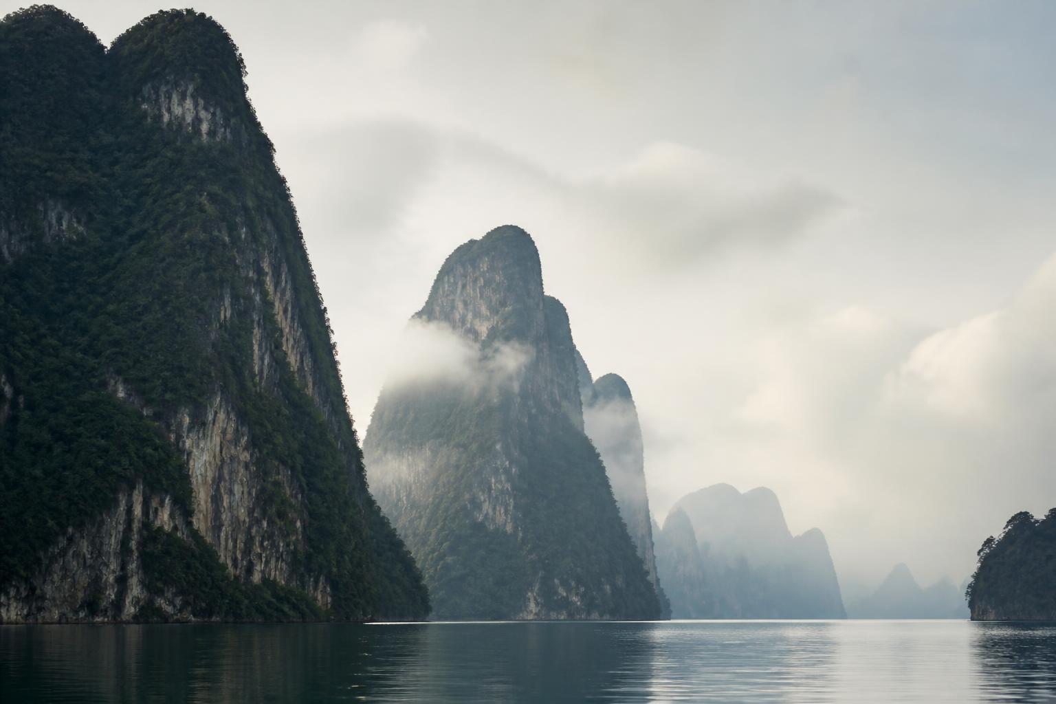 Limestone karst mountains rising from the bay near the estate